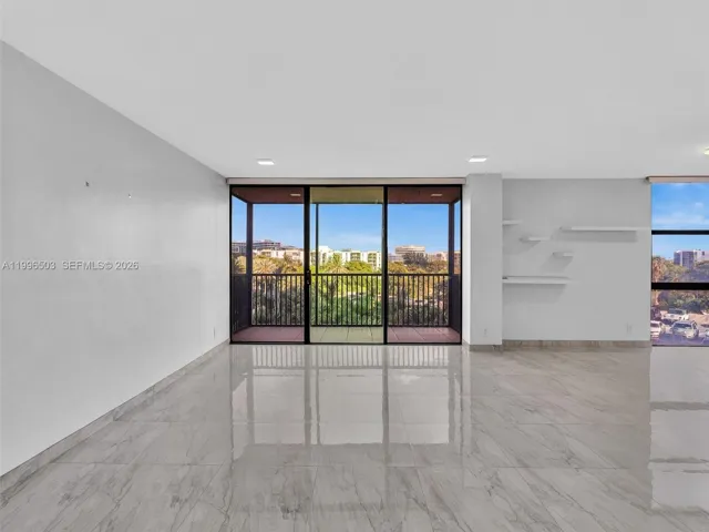 Spacious living area with natural light and balcony view