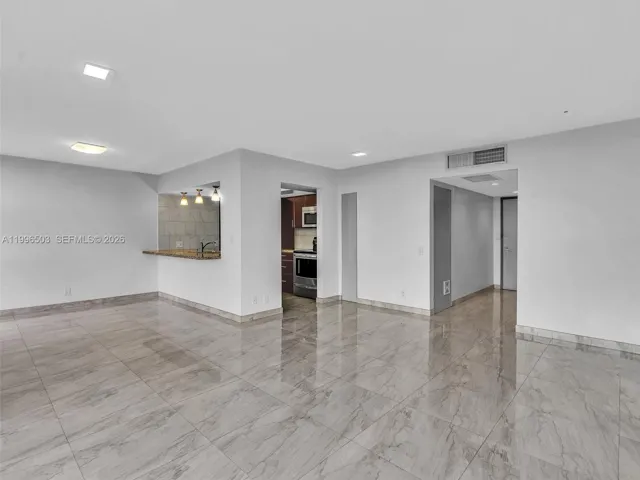 Living room from another angle showing open layout and Kitchen access