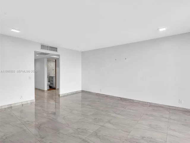 Living room with view toward entry and hallway