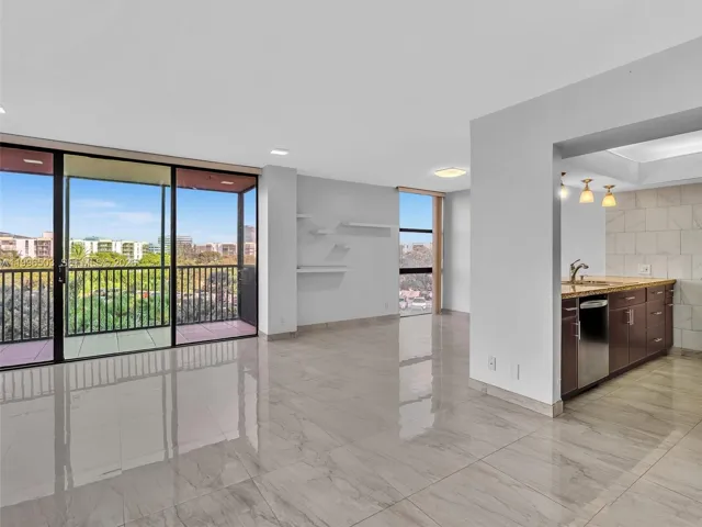 Open living area with balcony view and kitchen access