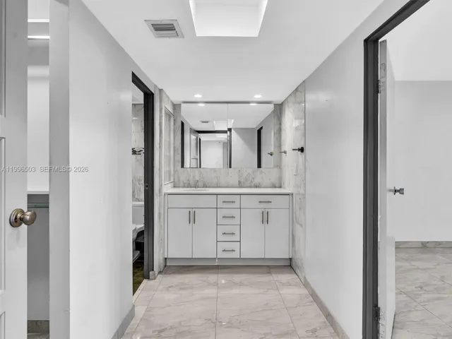 Entry to private bedroom suite with bedroom to the right and bathroom area