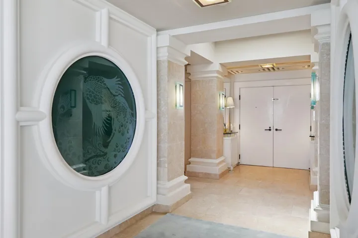 Etched glass peacocks create a striking entry
