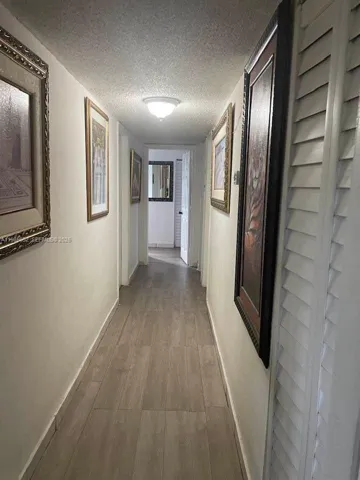 HALLWAY LEADING TO 3 BEDROOMS AND GUEST RESTROOM. ADDITIONAL RESTROOM INSIDE MASTER