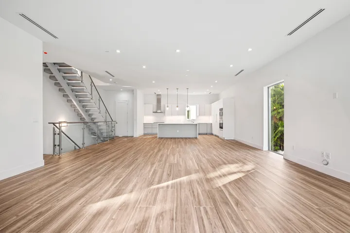 Bright, open, kitchen and living space with Miele and Samsung appliances.