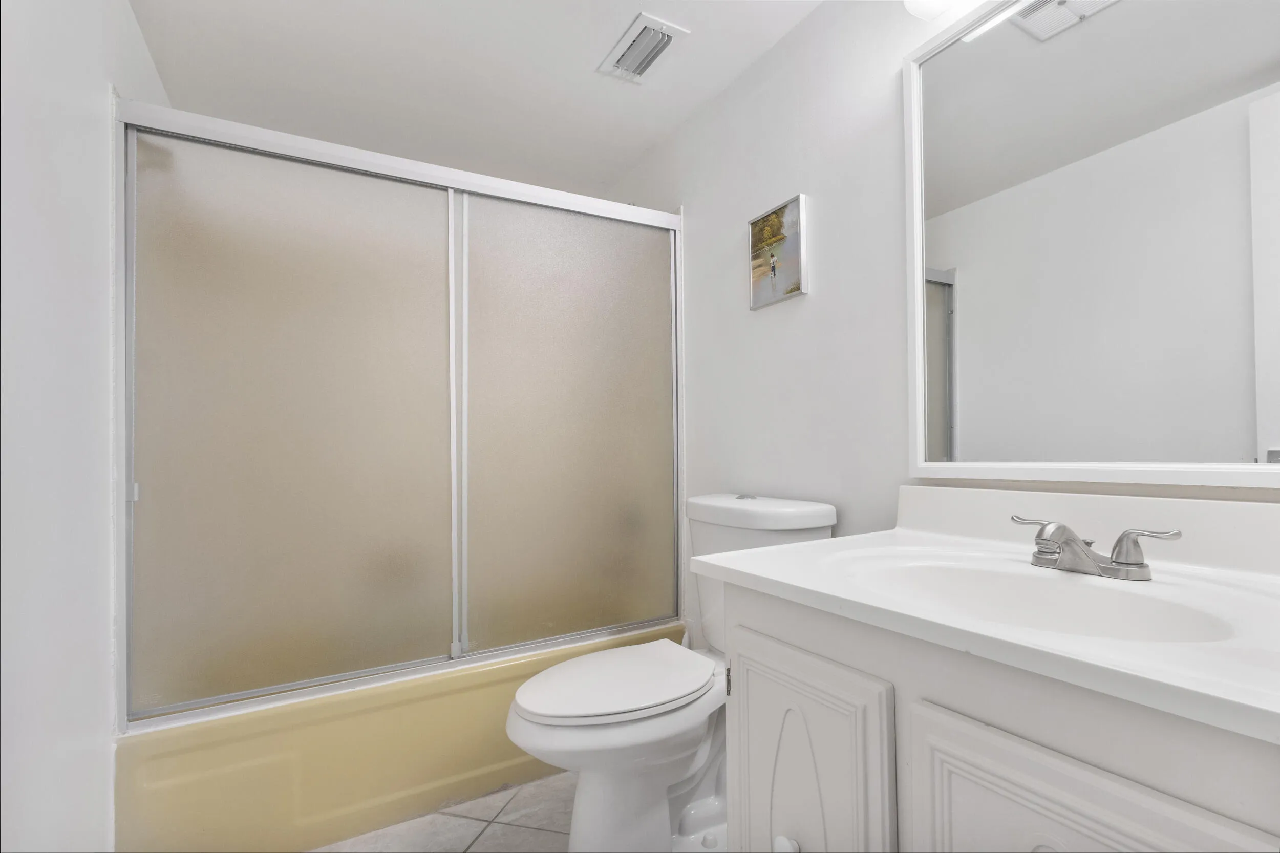 Primary bathroom featuring a shower and tub combo.
