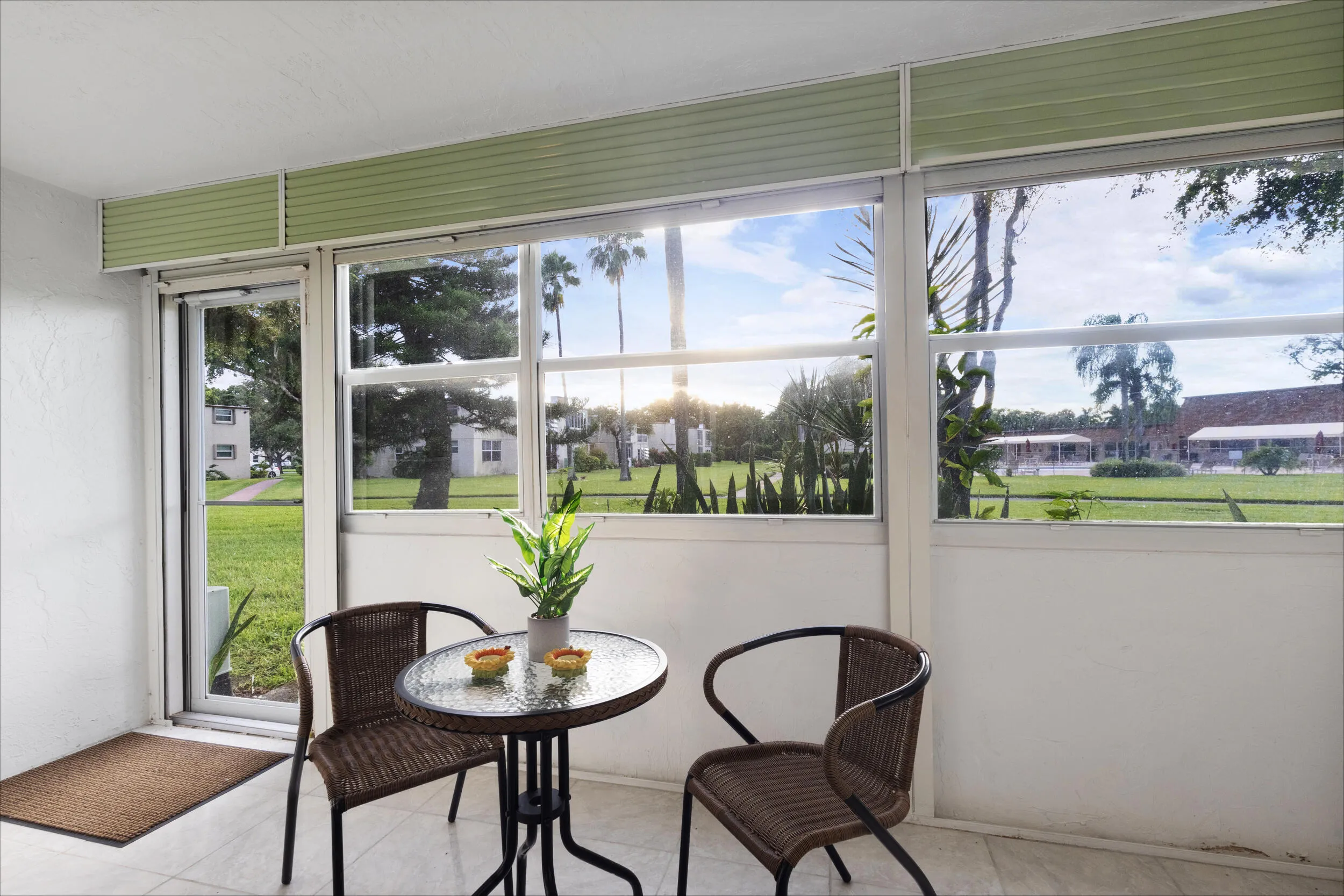 Extension of the living room flows into the Florida room over looking the walking trails and community pool/clubhouse.