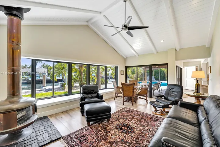 Living Room with large bay windows overlooking the water with wood burning fireplace