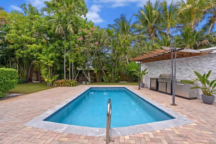 Back patio, pool, and outdoor kitchen.