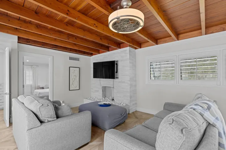 Living room with exposed beam ceilings.