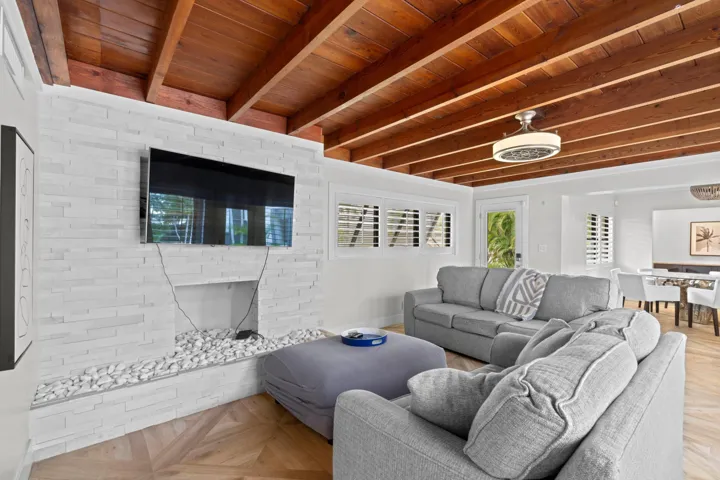 Living room with exposed beam ceilings.