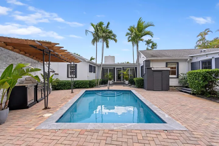 Backyard with pool & outdoor kitchen.