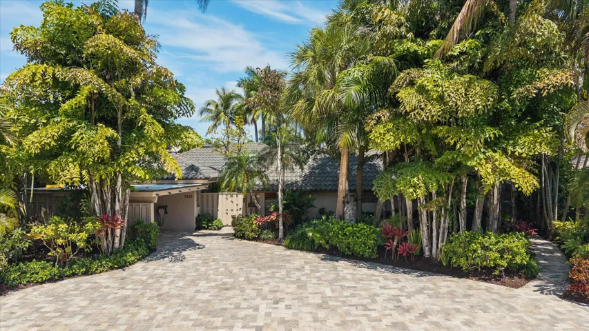 Lavish landscaping surrounds property with private gate to enter this fully renovated, secluded retreat.