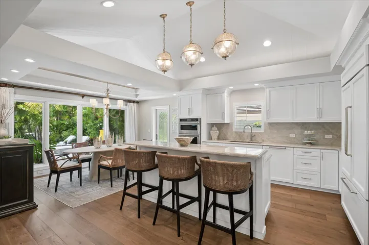 Fully renovated kitchen with breakfast bar, paneled Subzero refrigerator/freezer, Thermador 5 burner kitchen island gas stove, Thermador dishwasher, KitchenAid built-in wall oven and microwave and Kohler sink.