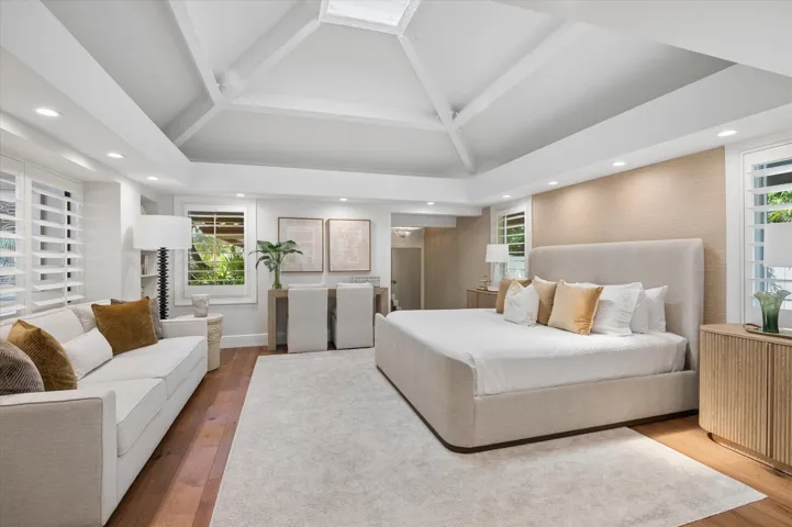 Primary Suite with vaulted ceiling and skylight, custom closet and private ensuite