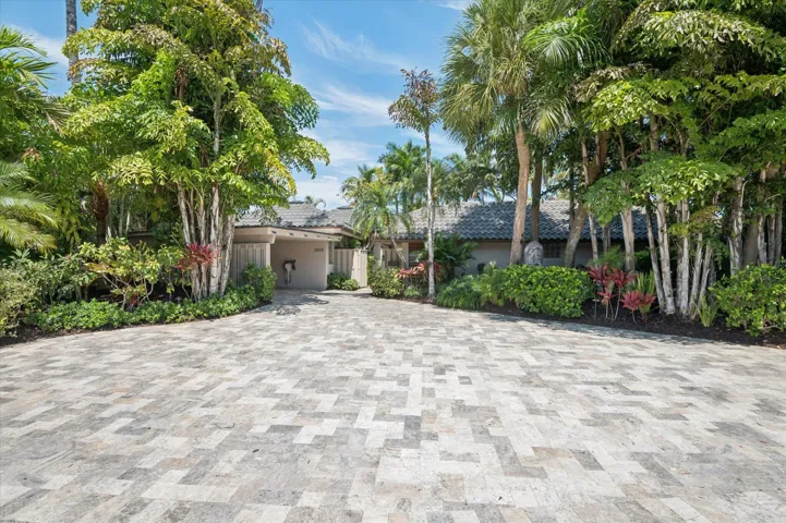 Lavish landscaping surrounds property with private gate to enter this fully renovated, secluded retreat.