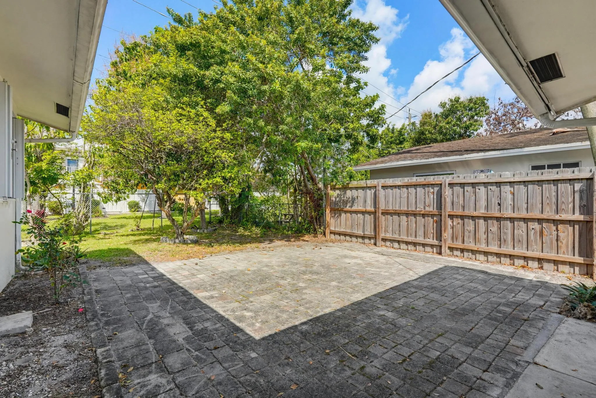 Plenty of space for outdoor living and a brick paver patio