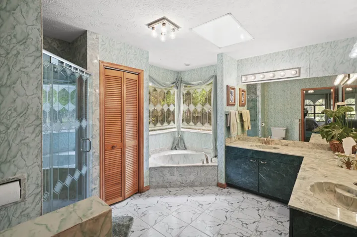 Spa-inspired bathroom with elegant tub with separate shower.