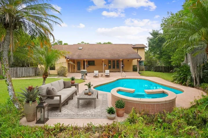 Virtually staged seating around freeform pool and spa.