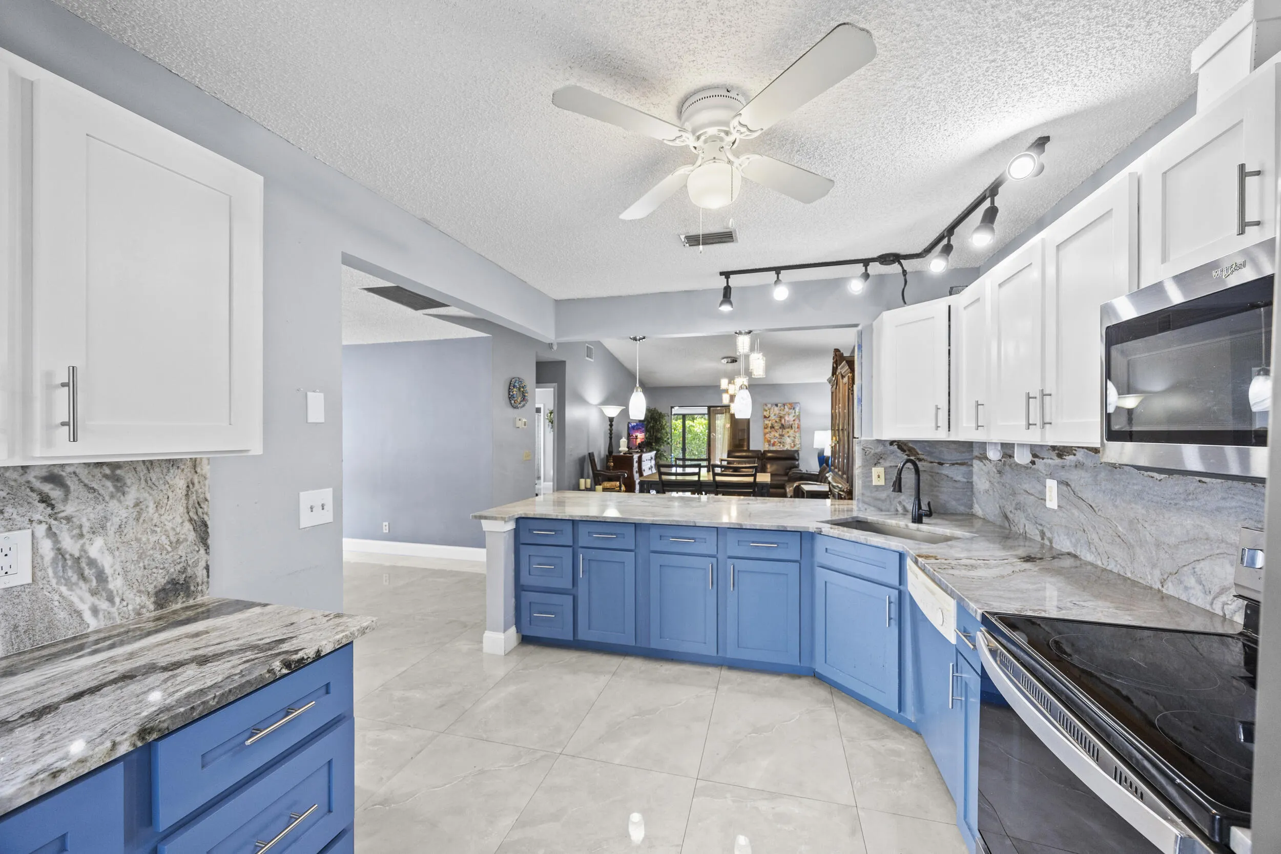 Updated kitchen with modern finishes, featuring sleek cabinetry, ample counter space, and a functional layout that opens seamlessly to the dining and living areas—perfect for both everyday living and entertaining.