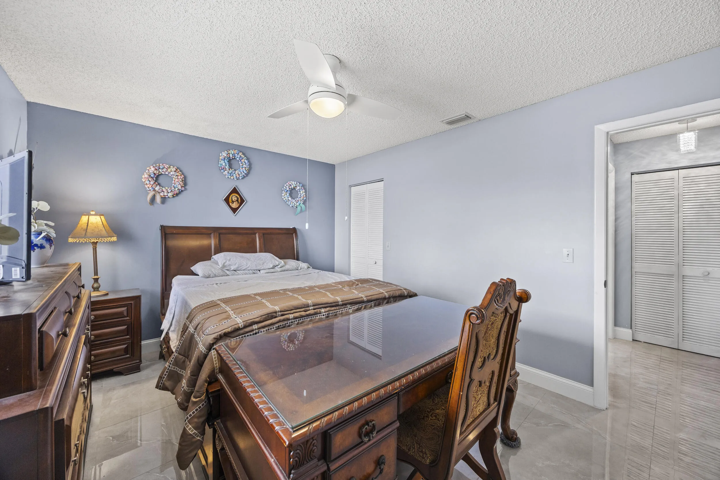 Spacious guest bedroom with a clean, comfortable layout, offering plenty of natural light and flexibility for visitors or a home office setup.