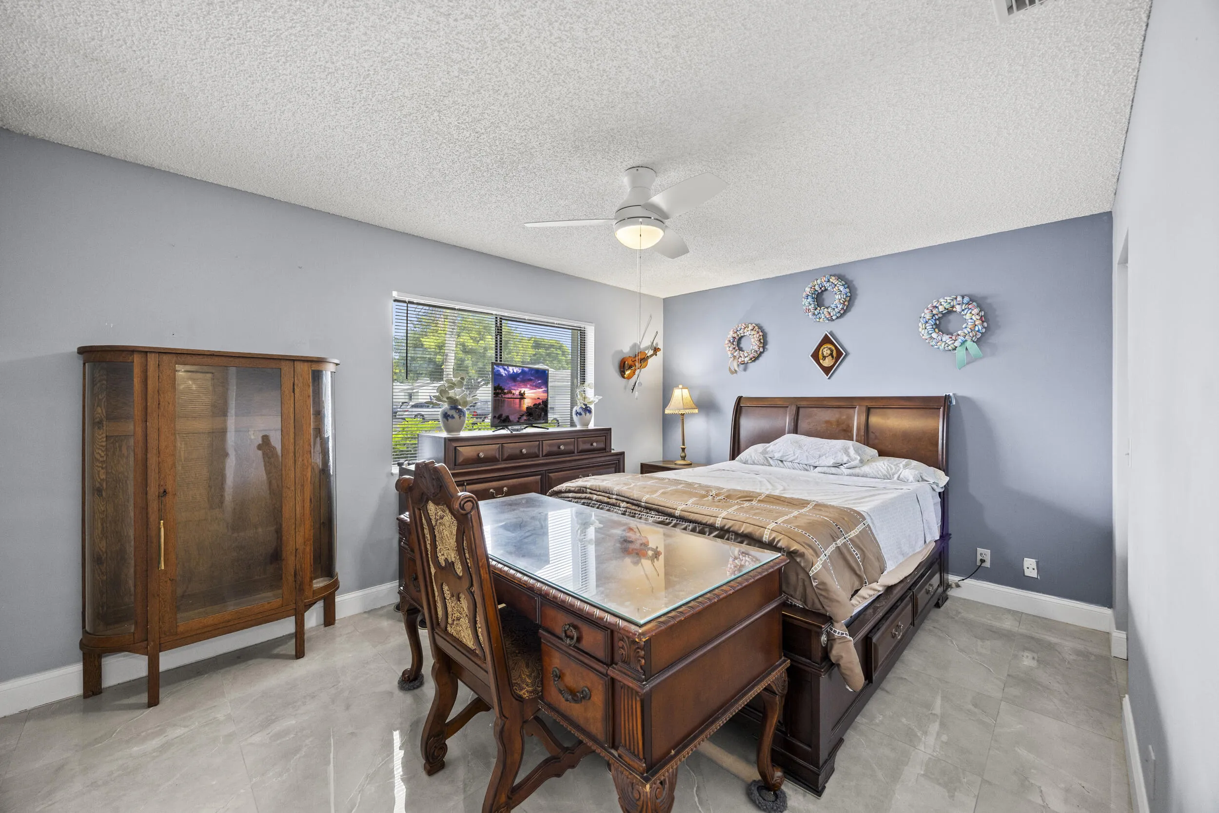 Spacious guest bedroom with a clean, comfortable layout, offering plenty of natural light and flexibility for visitors or a home office setup.