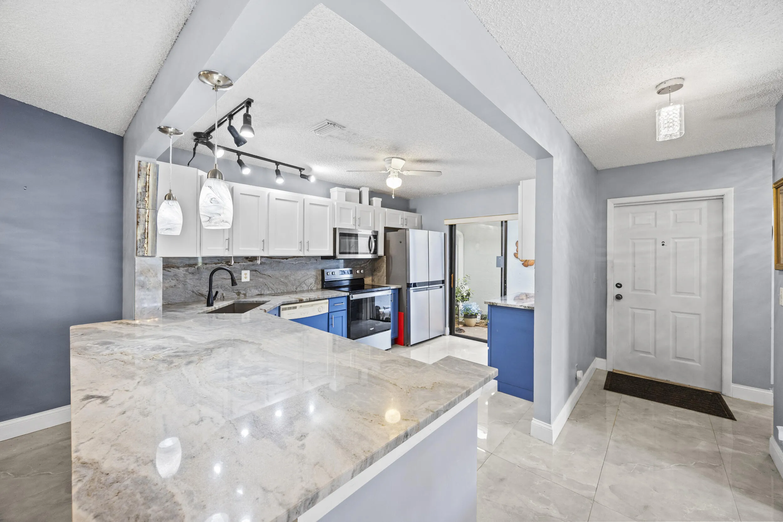 Updated kitchen with modern finishes, featuring sleek cabinetry, ample counter space, and a functional layout that opens seamlessly to the dining and living areas—perfect for both everyday living and entertaining.