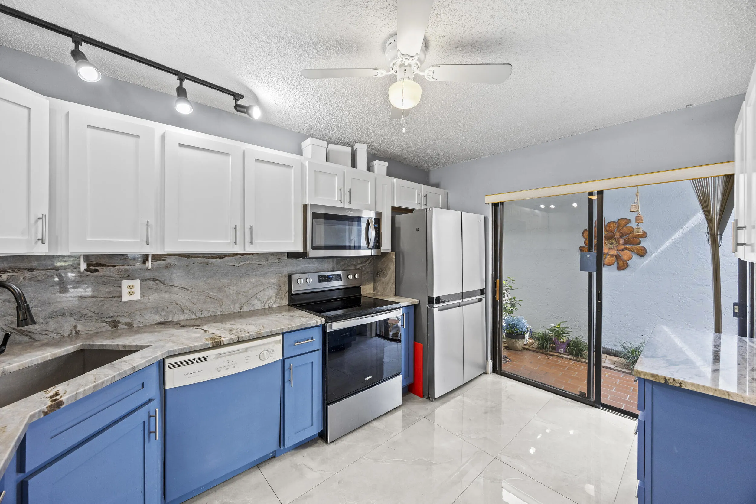 Updated kitchen with modern finishes, featuring sleek cabinetry, ample counter space, and a functional layout that opens seamlessly to the dining and living areas—perfect for both everyday living and entertaining.