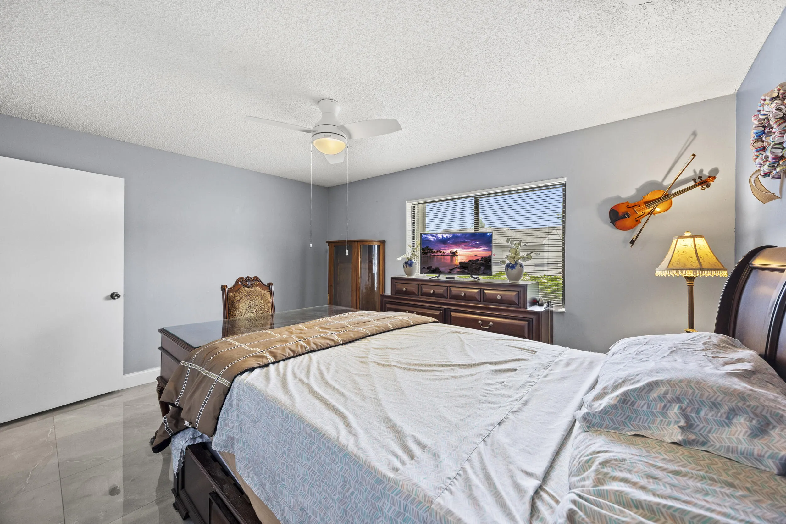 Spacious guest bedroom with a clean, comfortable layout, offering plenty of natural light and flexibility for visitors or a home office setup.
