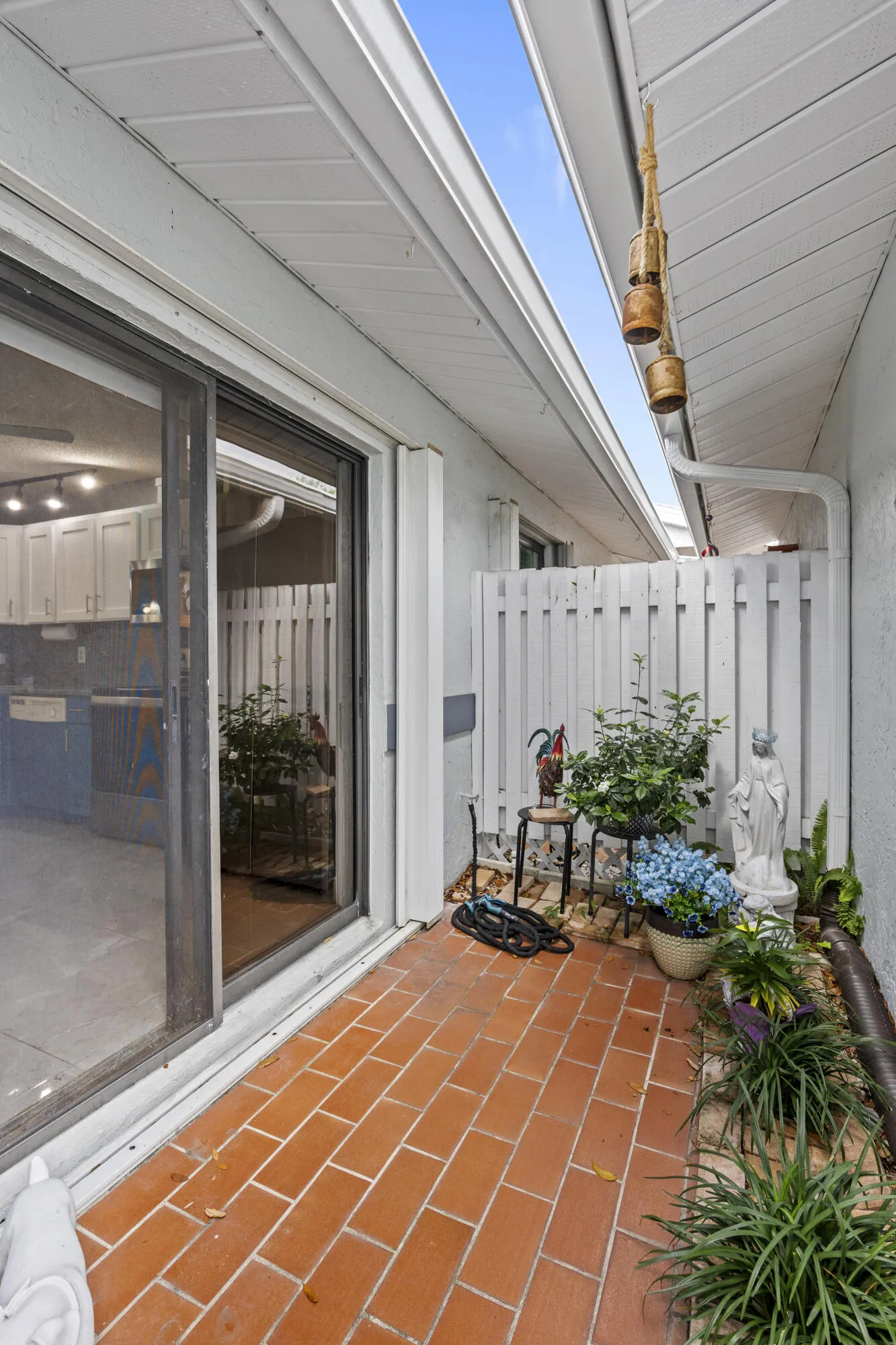 Private, welcoming entry with a charming courtyard feel, featuring a quaint garden space that adds a touch of character and a warm first impression as you arrive.