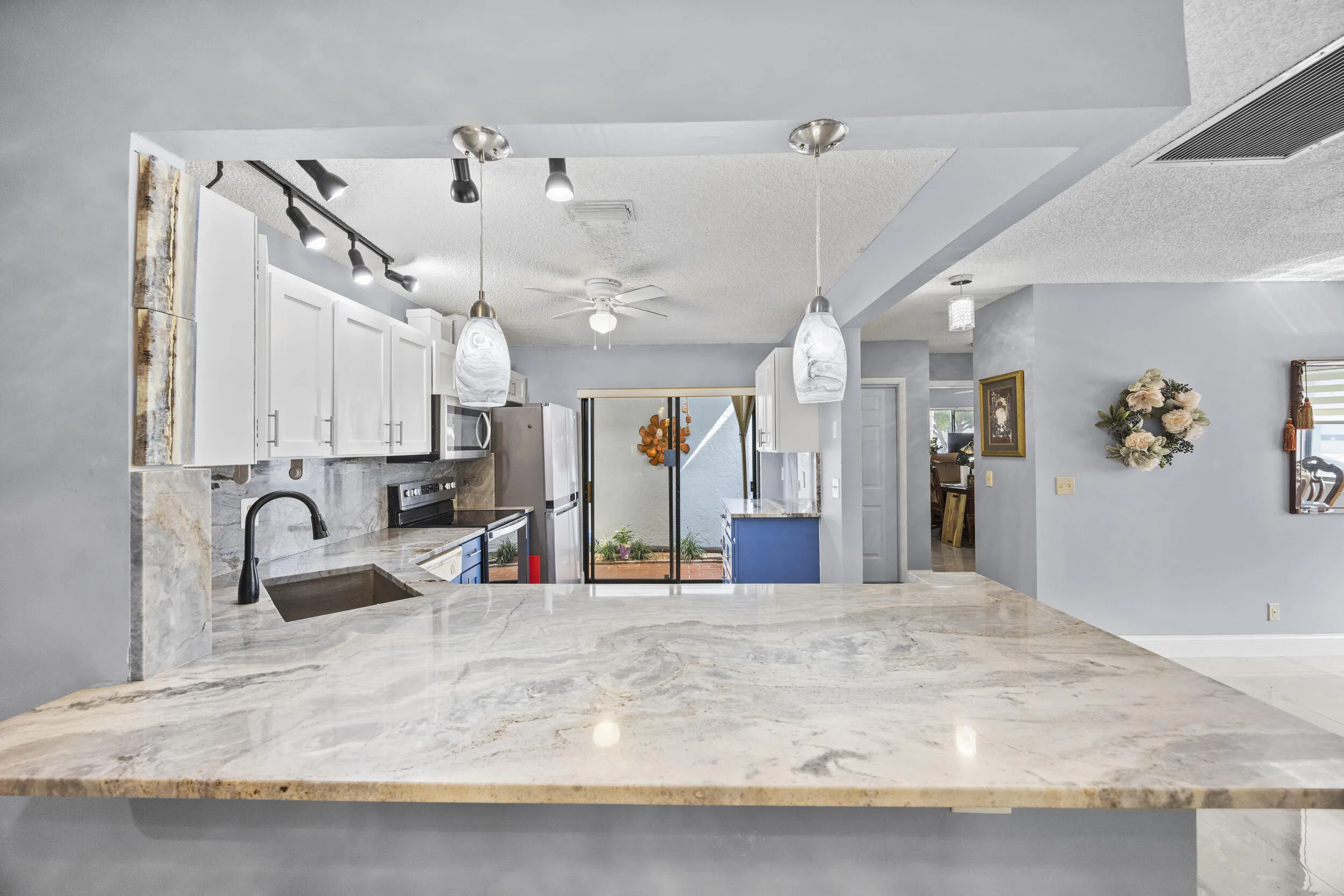 Expansive breakfast bar with beautiful countertop space, perfect for casual dining, morning coffee, or gathering with guests while staying connected to the kitchen and living areas.