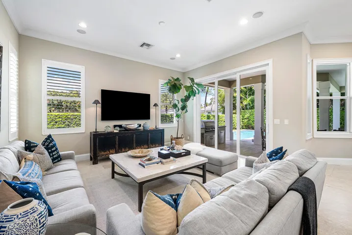 Family Room opens to covered lanai and outdoor kitchen.