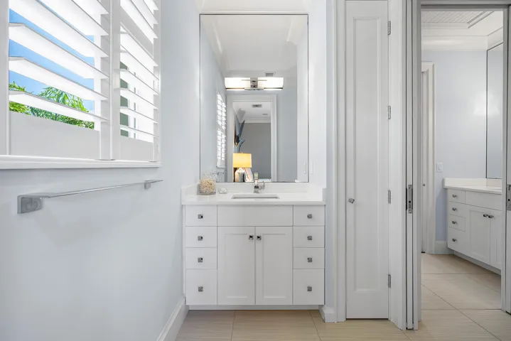 Upstairs Jack and Jill bathroom with separate vanities and a walk in shower.