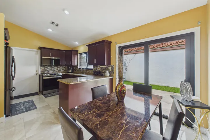Kitchen with breakfast table with sliding door to side patio