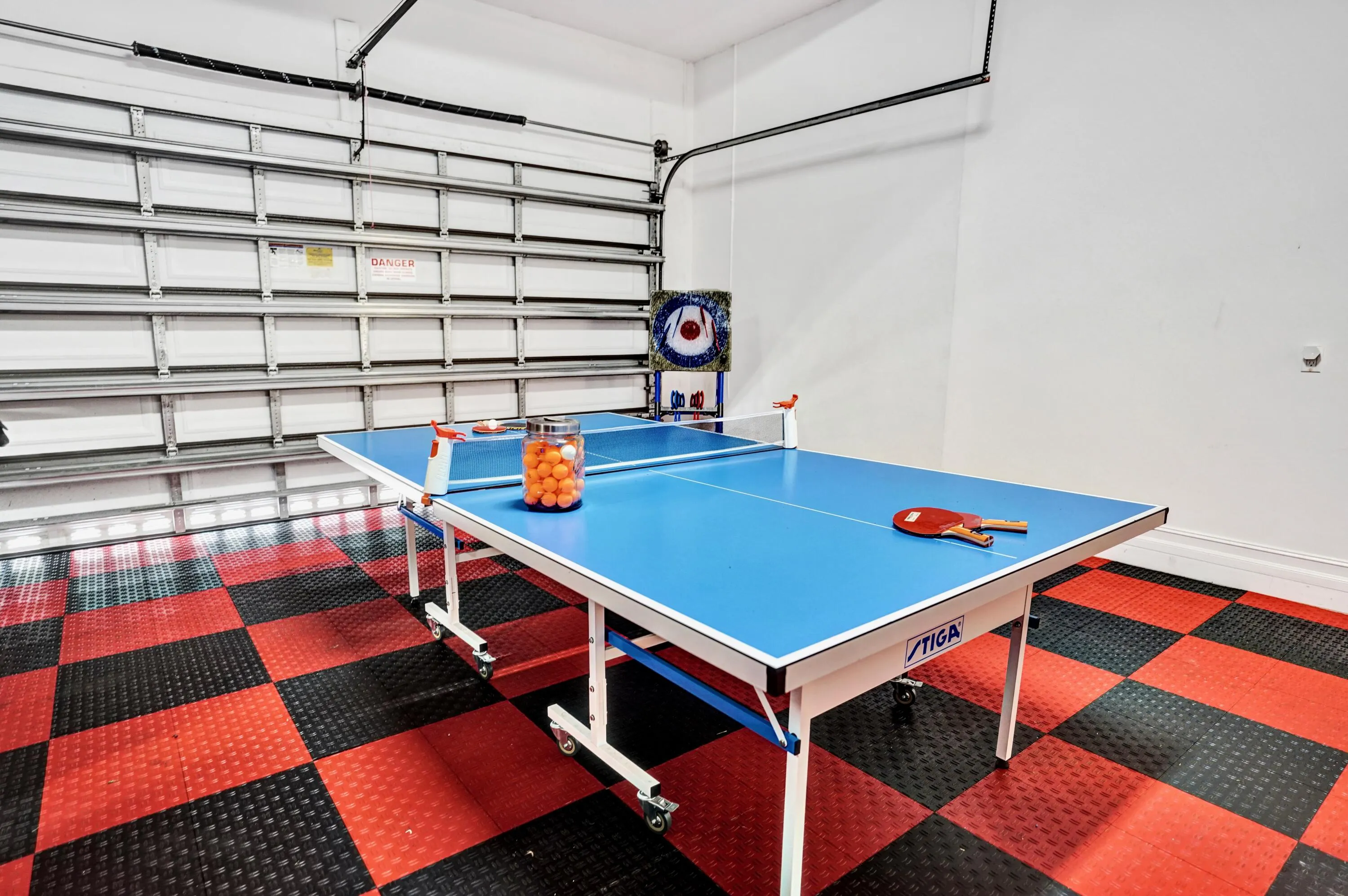 Garage has interlocking tile floors.