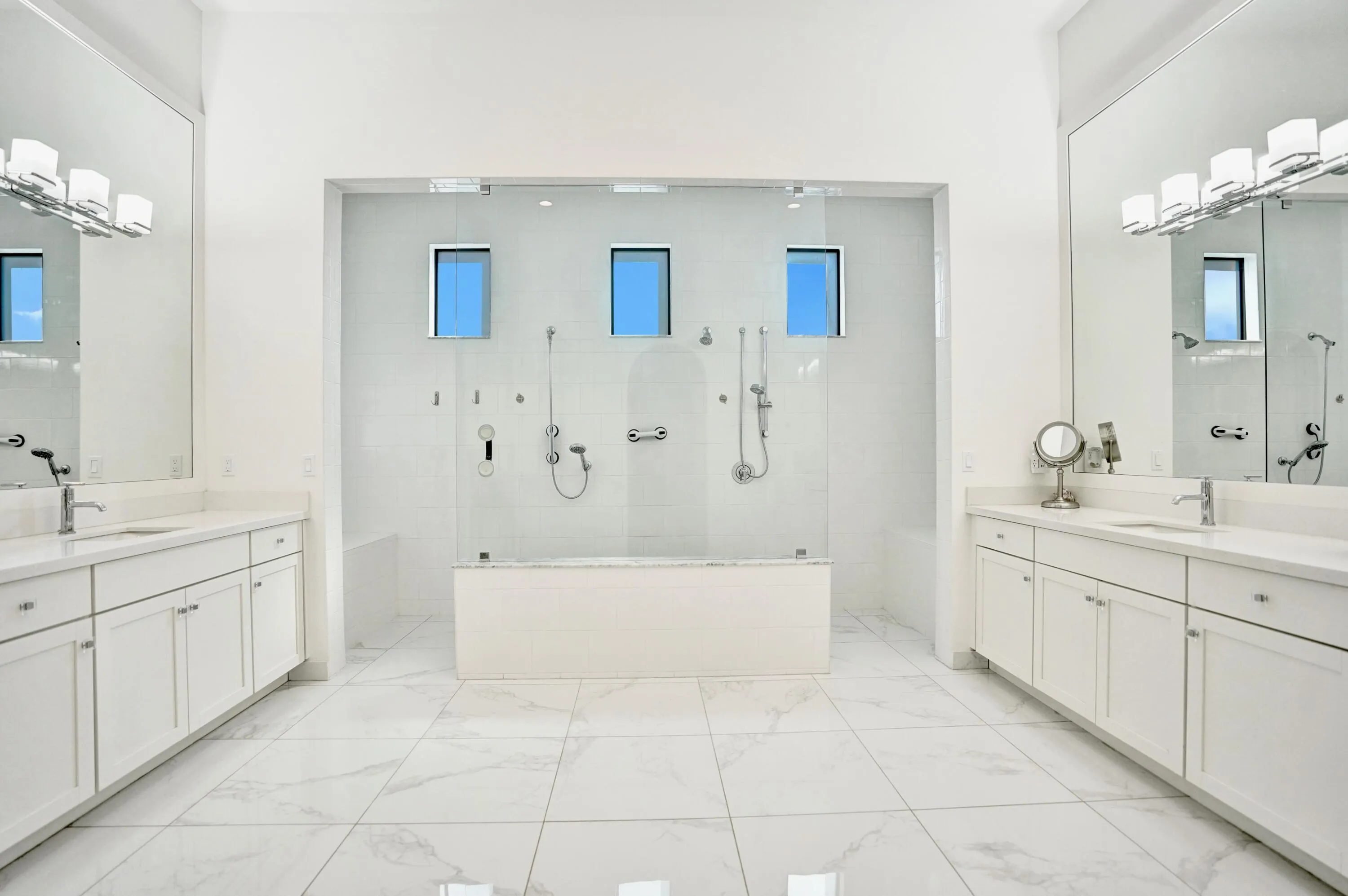 Large primary bathroom with oversized double shower and double vanities.