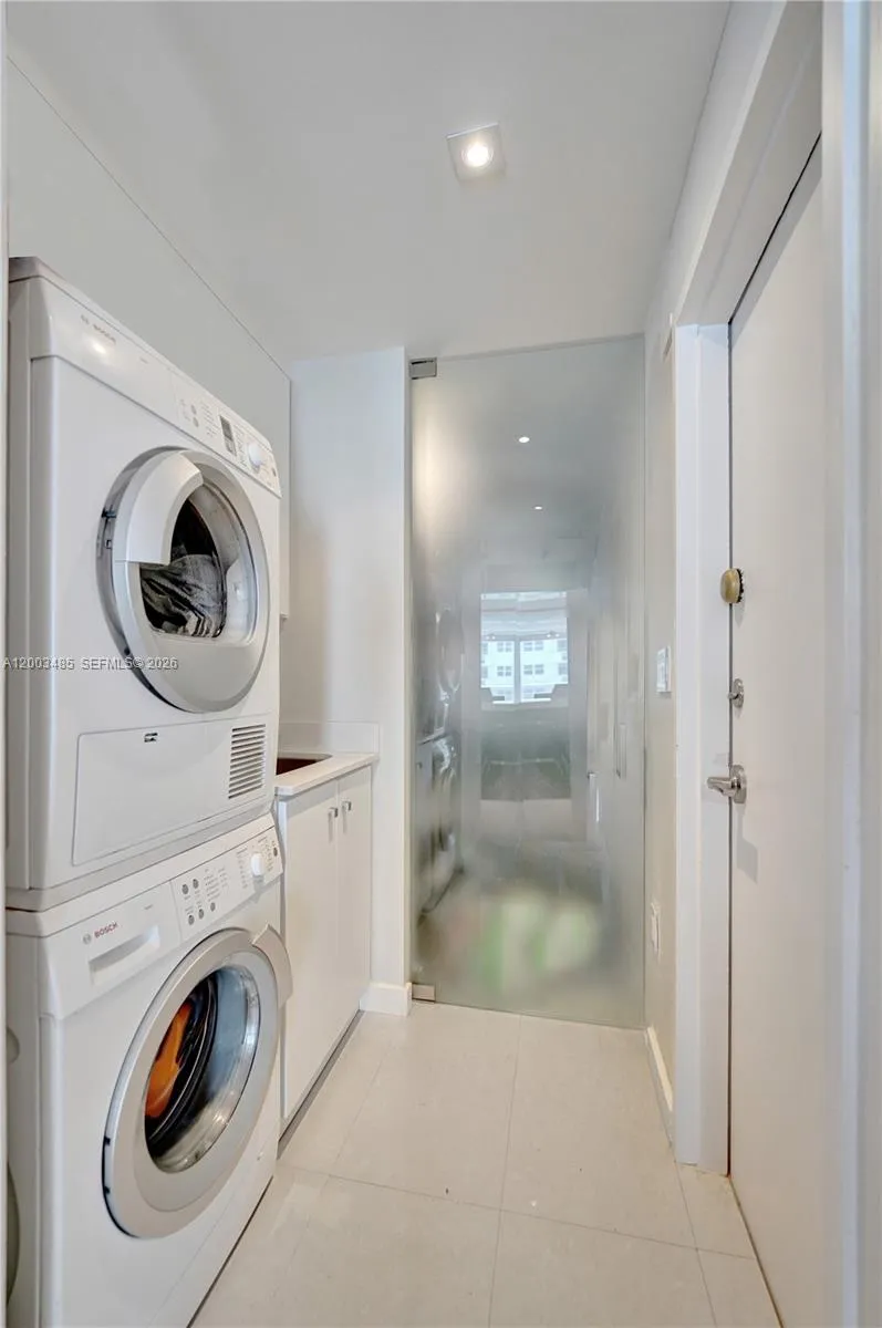 Full Size Bosch Washer/Dryer laundry room with utility sink and Pantry