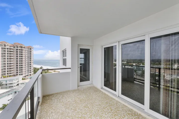 View past the impact sliders from large balcony toward beach