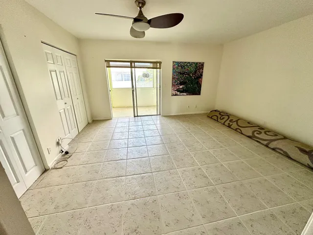 The bedroom has a sliding glass door to the patio