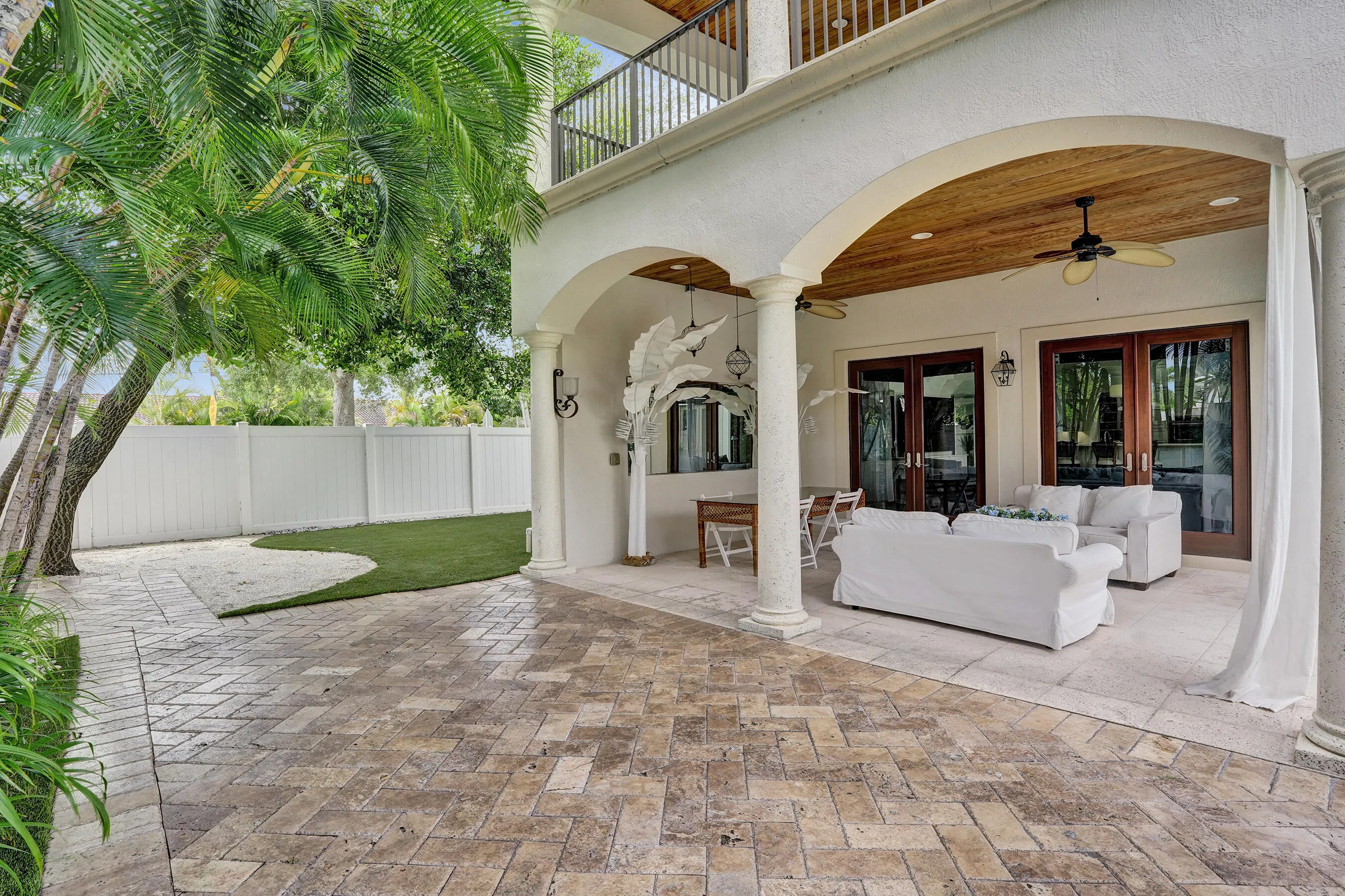 Large covered porch off the Family room. Above is the private covered deck of the Master suite