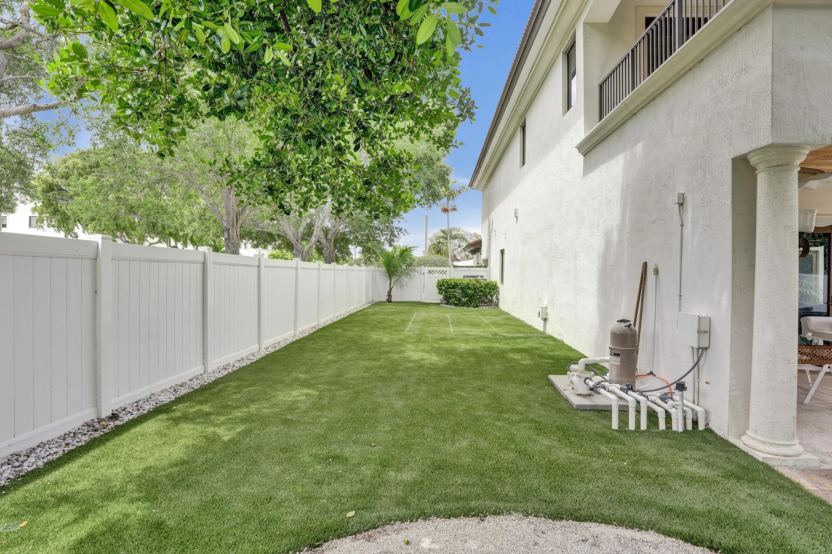 Large side yard with clean and bright turf.