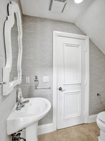 Half bath for guests and connects to first floor office/5th bedroom