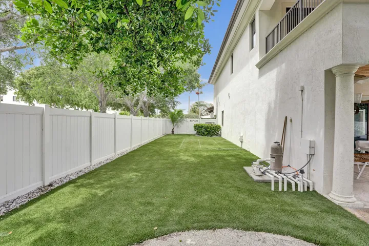 Large side yard with clean and bright turf.