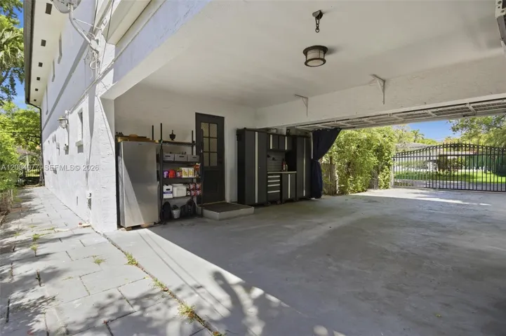 Open Carport accommodates 2 covered spaces + 2 on driveway inside gate