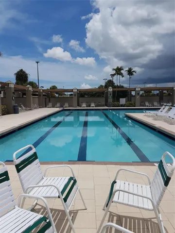 Main Pool with gym, hot tub, and lazy river pool.