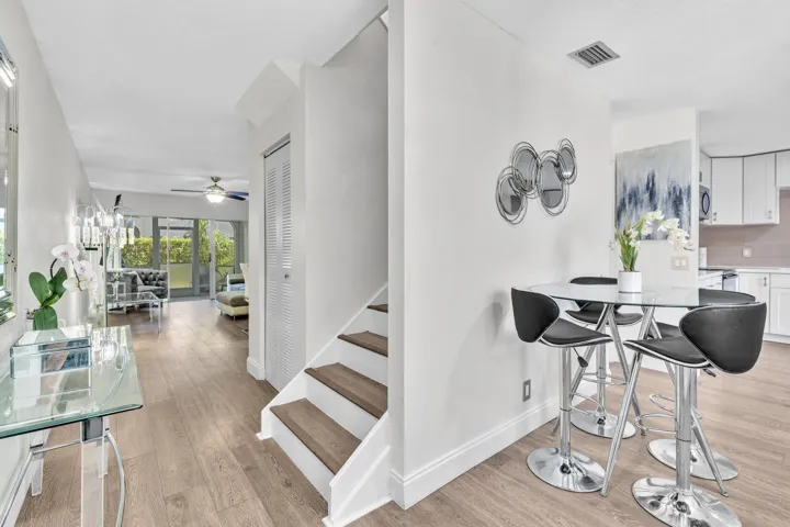 Kitchen & Staircase Leading to 2 Primary Suites