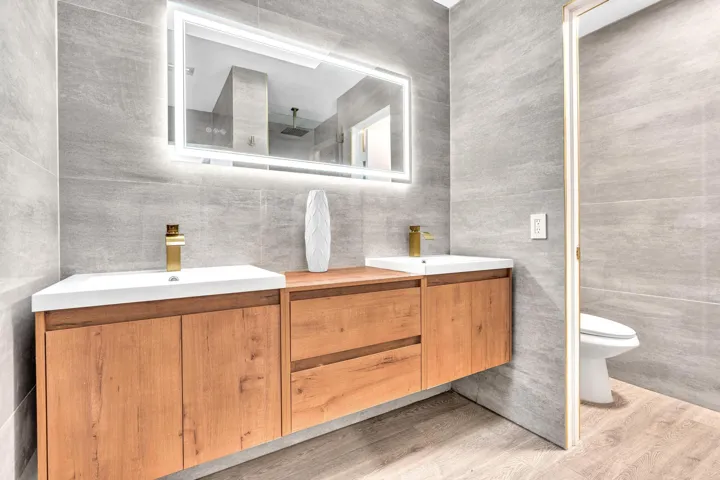 Primary Bathroom #1 with Floor to Ceiling Tile & Floating Natural Wood Vanity