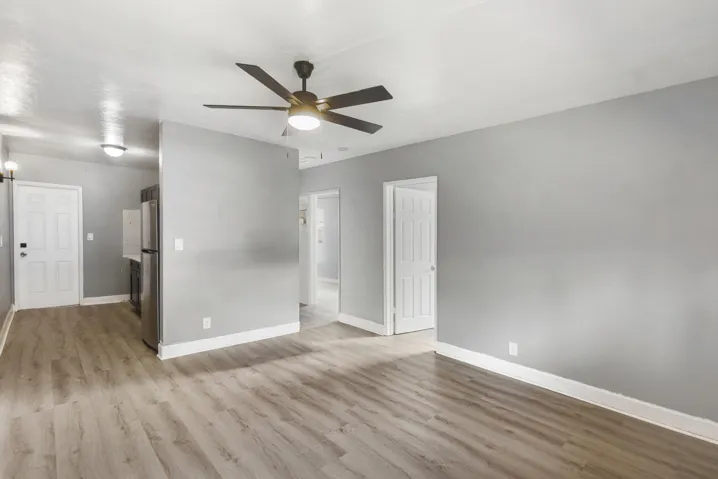 Living room with window unit and ceiling fan.
