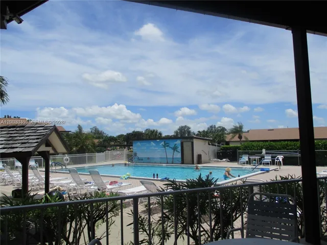 POOL SURROUNDED BY CHAIRS FOR SUN BATHERS