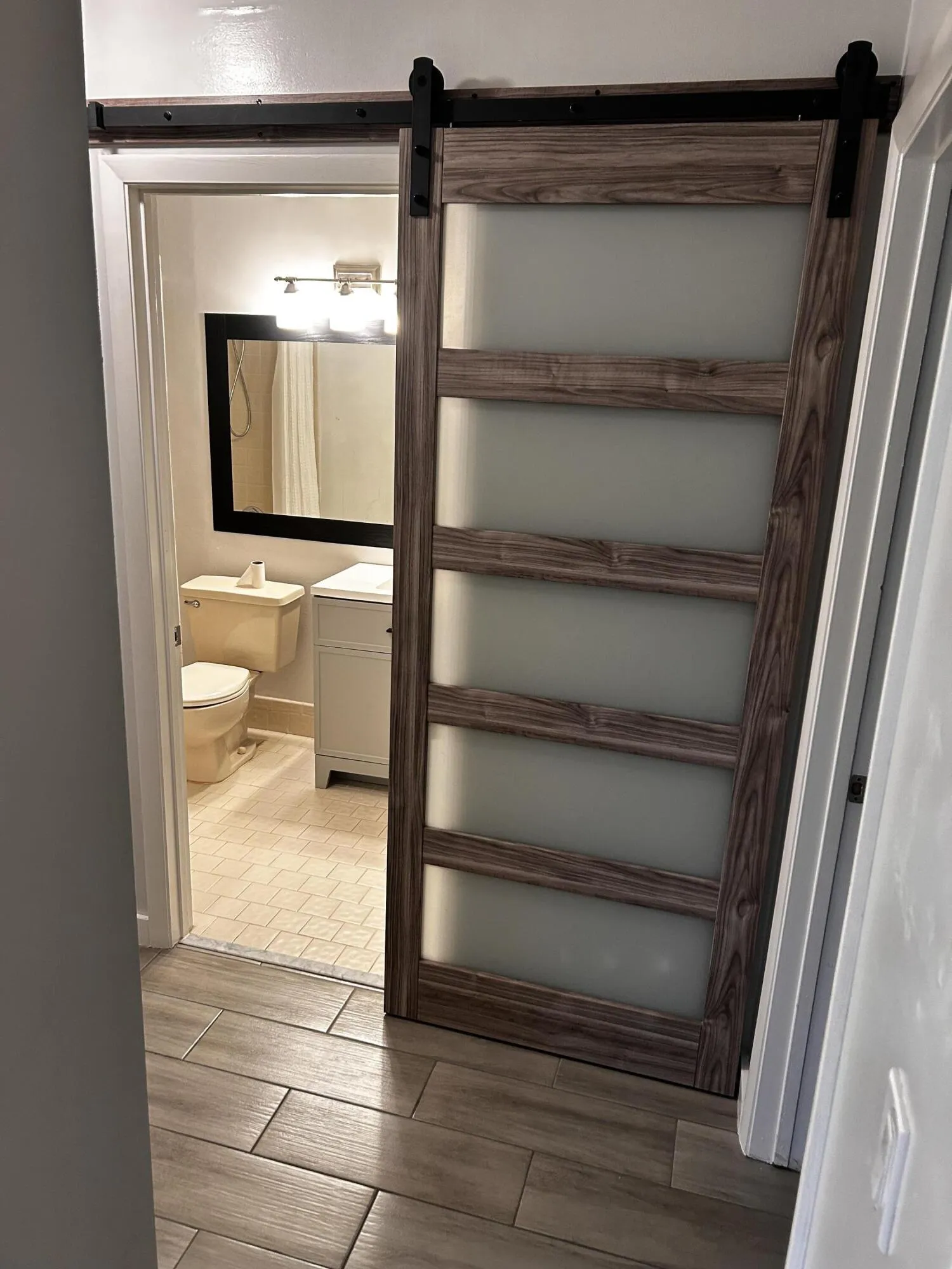 guest bathroom with barndoor