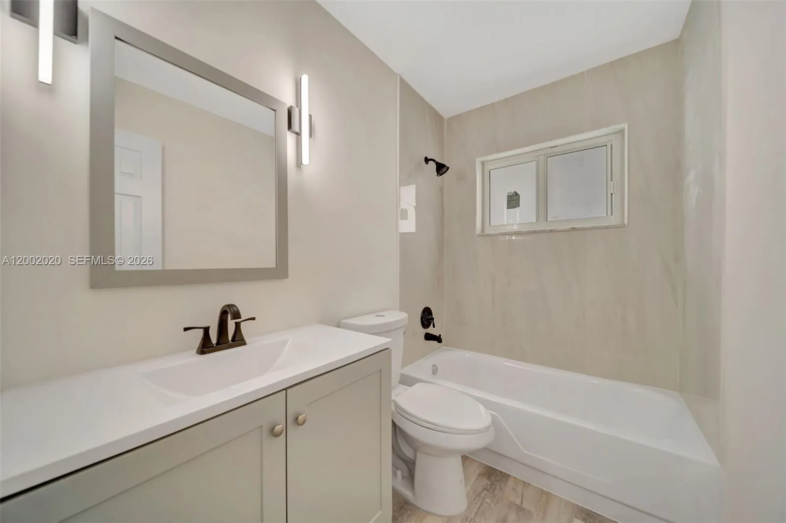 Bathroom 1 — new tub, vanity, fixtures, and tile